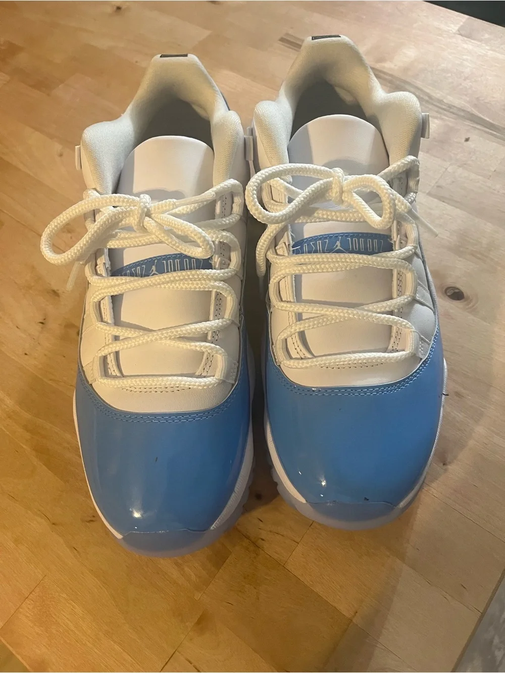 UNC Jordan 11 Low-Top Sneakers in White and Light Blue Patent